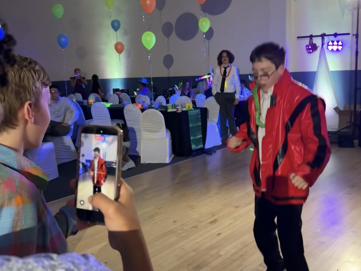 Judah in the Thriller jacket on the dance floor while a friend films