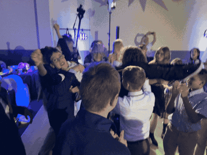 Judah's friends lifting him into the air on the dance floor
